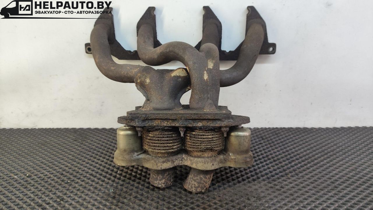 коллектор выпускной Volvo 460 1 поколение 1993, 2.0 л., бензин, МКПП, зелёный, седан, передний привод - фото №1