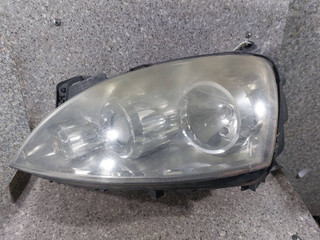 фара левая Opel Corsa C [рестайлинг] (2003 - 2006), 13100535