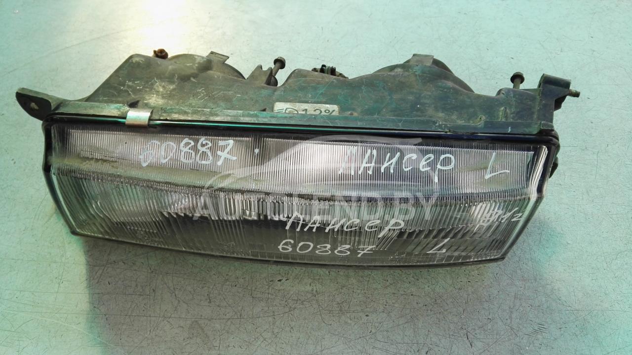 фара левая Mitsubishi Lancer 4 поколение 1990, 1.5 л., бензин, МКПП, хетчбэк 5 дв. - фото №1